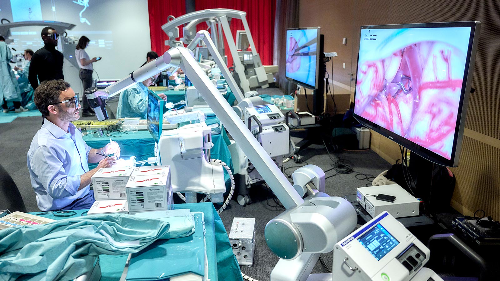 Photo of a neurosurgeon in front of the 4D aneurysm simulator